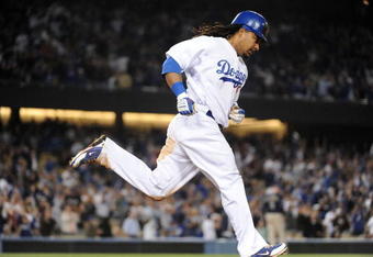 LOS ANGELES, CA - APRIL 30:  Manny Ramirez #99 of the Los Angeles Dodgers hits a homerun for a 4-3 lead against the San Diego Padres during the third inning at Dodger Stadium on April 30, 2009 in Los Angeles, California.  (Photo by Harry How/Getty Images)