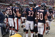 CHICAGO - DECEMBER 07: Adewale Ogunleye #93, Brian Urlacher #54, Charles Tillman #33 and Mike Brown #30 of the Chicago Bears stand in front of heaters to warm up during a game against the Jacksonville Jaguars on December 7, 2008 at Soldier Field in Chicago, Illinois. The Bears defeated the Jaguars 23-10. (Photo by Jonathan Daniel/Getty Images)