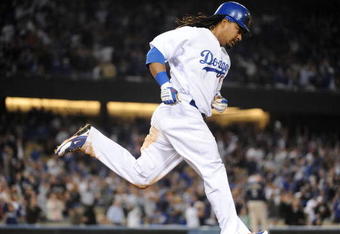 LOS ANGELES, CA - APRIL 30:  Manny Ramirez #99 of the Los Angeles Dodgers hits a homerun for a 4-3 lead against the San Diego Padres during the third inning at Dodger Stadium on April 30, 2009 in Los Angeles, California.  (Photo by Harry How/Getty Images)