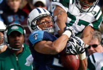 NASHVILLE, TN - NOVEMBER 23:  Cortland Finnegan #31 of the Tennessee Titans intercepts this pass intended for Laveranues Coles #87 of the New York Jets during the game at LP Field on November 23, 2008 in Nashville, Tennessee.  (Photo by Kevin C. Cox/Getty Images)