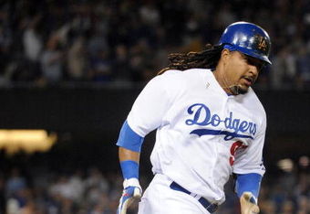 LOS ANGELES, CA - APRIL 30:  Manny Ramirez #99 of the Los Angeles Dodgers hits a homerun for a 4-3 lead against the San Diego Padres during the third inning at Dodger Stadium on April 30, 2009 in Los Angeles, California.  (Photo by Harry How/Getty Images)