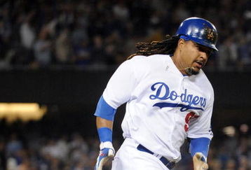 LOS ANGELES, CA - APRIL 30:  Manny Ramirez #99 of the Los Angeles Dodgers hits a homerun for a 4-3 lead against the San Diego Padres during the third inning at Dodger Stadium on April 30, 2009 in Los Angeles, California.  (Photo by Harry How/Getty Images)