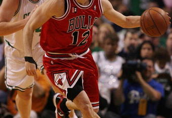 BOSTON - MAY 02:  Kirk Hinrich #12 of the Chicago Bulls heads down court as Brian Scalabrine #44 of the Boston Celtics defends in Game Seven of the Eastern Conference Quarterfinals during the 2009 NBA Playoffs at TD Banknorth Garden on May 2, 2009 in Boston, Massachusetts. The Celtics defeated the Bulls 109-99. NOTE TO USER: User expressly acknowledges and agrees that, by downloading and or using this photograph, User is consenting to the terms and conditions of the Getty Images License Agreement.  (Photo by Elsa/Getty Images)