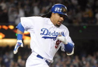 LOS ANGELES, CA - APRIL 30:  Manny Ramirez #99 of the Los Angeles Dodgers hits a homerun for a 4-3 lead against the San Diego Padres during the third inning at Dodger Stadium on April 30, 2009 in Los Angeles, California.  (Photo by Harry How/Getty Images)