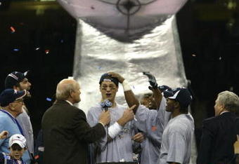 3 Feb 2002:   Quarterback Tom Brady #12 of the New England Patriots speaks with sports commentator Terry Bradshaw, left, at the podium after Super Bowl XXXVI between the New England Patriots and the St. Louis Rams at the Superdome in New Orleans, Louisiana. The Patriots defeated the Rams 20-17 with a 48-yard field goal by kicker Adam Vinatieri. DIGITAL IMAGE.  Mandatory Credit: Brian Bahr/Getty Images
