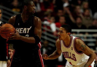 CHICAGO - FEBRUARY 12:  Dwyane Wade #3 of the Miami Heat looks to pass as Derrick Rose #1 of the Chicago Bulls defends on February 12, 2009 at the United Center in Chicago, Illinois. The Heat defeated the Bulls 95-93. NOTE TO USER: User expressly acknowledges and agreees that, by downloading and/or using this Photograph, User is consenting to the terms and conditions of the Getty Images License Agreement.  (Photo by Jonathan Daniel/Getty Images)