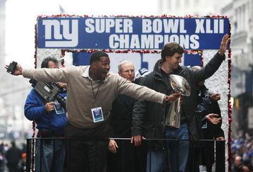 NEW YORK - FEBRUARY 05:  (L-R) Michael Strahan, Head coach Tom Coughlin and Eli Manning of the New York Giants ride in a float along Broadway, also known as 'The Canyon of Heroes' during Super Bowl XLII victory parade in New York City.  (Photo by Al Bello/Getty Images)