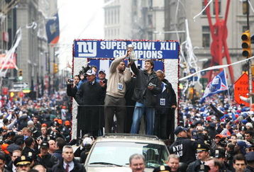 NEW YORK - FEBRUARY 05:  (L-R) Mayor of New York Michael Bloomberg, Michael Strahan and Eli Manning of the New York Giants ride in a float along Broadway, also known as 'The Canyon of Heroes' during Super Bowl XLII victory parade in New York City.  (Photo by Al Bello/Getty Images)