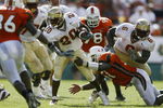 MIAMI - OCTOBER 12:   Running back Nick Maddox #20 of Florida State fights for yardage as linebacker Jonathan Vilma #51 of Miami grabs his left thigh during the game on October 12, 2002 at the Orange Bowl in Miami, Florida.  Miami edged Florida State 28-27.  (Photo by Andy Lyons/Getty Images)