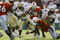 MIAMI - OCTOBER 12:   Running back Nick Maddox #20 of Florida State fights for yardage as linebacker Jonathan Vilma #51 of Miami grabs his left thigh during the game on October 12, 2002 at the Orange Bowl in Miami, Florida.  Miami edged Florida State 28-27.  (Photo by Andy Lyons/Getty Images)