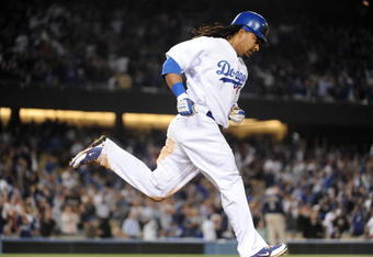 LOS ANGELES, CA - APRIL 30:  Manny Ramirez #99 of the Los Angeles Dodgers hits a homerun for a 4-3 lead against the San Diego Padres during the third inning at Dodger Stadium on April 30, 2009 in Los Angeles, California.  (Photo by Harry How/Getty Images)