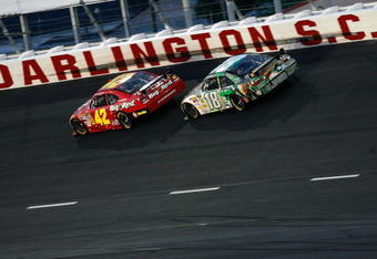 DARLINGTON, SC - MAY 10: Juan Pablo Montoya, driver of the #42 Wrigley's Big Red Dodge, leads Kyle Busch, driver of the #18 M&M's Indiana Jones Toyota, during the NASCAR Sprint Cup Series Dodge Challenger 500 on May 10, 2008 at Darlington Raceway in Darlington, South Carolina.  (Photo by Kevin C. Cox/Getty Images)
