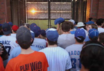 CHICAGO - OCTOBER 6:  Chicago Cubs fans watch the game from an opening in the fence outside Wrigley Field as the Chicago Cubs play the Arizona Diamondbacks in the National League Division Series October 6, 2007 in Chicago, Illinois. The Cubs, who have not won a World Series in 99 years, were swept in three straight games by the Diamondbacks.  (Photo by Scott Olson/Getty Images)