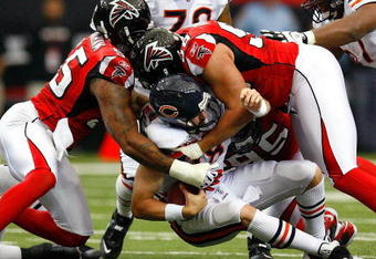 ATLANTA - OCTOBER 12:  Quarterback Kyle Orton #18 of the Chicago Bears is sacked by John Abraham #55 and Jamaal Anderson #98 of the Atlanta Falcons during the game at the Georgia Dome on October 12, 2008 in Atlanta, Georgia.  (Photo by Kevin C. Cox/Getty Images)