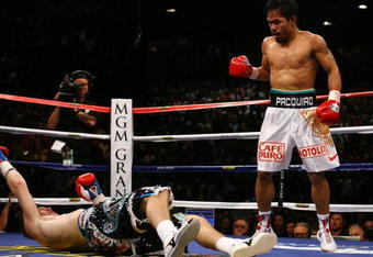 LAS VEGAS - MAY 02:  (R-L) Manny Pacquiao of the Philippines stands over Ricky Hatton of England after Pacquiao knocked him out in the second round during their junior welterweight title fight at the MGM Grand Garden Arena May 2, 2009 in Las Vegas, Nevada.  (Photo by Al Bello/Getty Images)