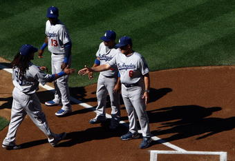 SAN DIEGO, CA- APRIL 6:  Manny Ramirez #99 of the Los Angeles Dodgers is greeted by Manager Joe Torre and teammates during introductions against the San Diego Padres during their Opening Day game on April 6, 2009 at Petco Park in San Diego, California. (Photo by Donald Miralle/Getty Images)