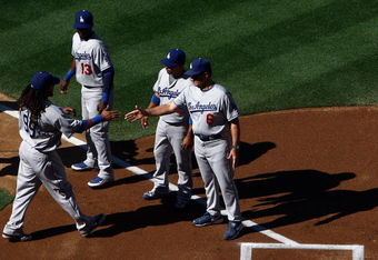 SAN DIEGO, CA- APRIL 6:  Manny Ramirez #99 of the Los Angeles Dodgers is greeted by Manager Joe Torre and teammates during introductions against the San Diego Padres during their Opening Day game on April 6, 2009 at Petco Park in San Diego, California. (Photo by Donald Miralle/Getty Images)
