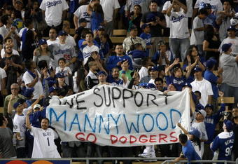 LOS ANGELES - MAY 7:  Fans hold a smuggled in banner supporting suspended Dodger Manny Ramirez during the seventh inning stretch of the game between the Los Angeles Dodgers the Washington Nationals on May 7, 2009 at Dodger Stadiium in Los Angeles, California.  All banners are prohibited in Dodger Stadium.  (Photo by Stephen Dunn/Getty Images)