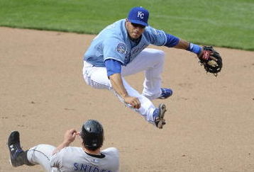 KANSAS CITY, MO - APRIL 30:  Mike Aviles #30 of the Kansas City Royals completes a double play against the Toronto Blue Jays as Travis Snider slides in on April 30, 2009 at Kauffman Stadium in Kansas City, Missouri. (Photo by G. Newman Lowrance/Getty Images)