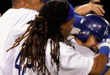 LOS ANGELES, CA - APRIL 15:  James Loney #7 (C) of the Los Angeles Dodgers is mobbed by teammates Matt Kemp #27 (L) Manny Ramirez #99 (CL) after Loney walked with the bases loaded to score Manny Ramirez for the winning run in the ninth inning against the San Francisco Giants at Dodger Stadium on April 15, 2009 in Los Angeles, California. All Major League Baseball players are wearing #42 in honor of Jackie Robinson day.  (Photo by Kevork Djansezian/Getty Images)