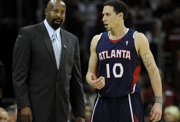 CLEVELAND - MAY 07:  Head coach Mike Woodson of the Atlanta Hawks talks with Mike Bibby #10 while playing the Cleveland Cavaliers in Game Two of the Eastern Conference Semifinals during the 2009 NBA Playoffs at Quicken Loans Arena on May 7, 2009 in Cleveland, Ohio. Cleveland won the game 105-85 to take a 2-0 series lead. NOTE TO USER: User expressly acknowledges and agrees that, by downloading and or using this photograph, User is consenting to the terms and conditions of the Getty Images License Agreement.  (Photo by Gregory Shamus/Getty Images)