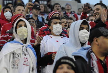 BRIDGEVIEW, IL - APRIL 29:  Soccer fans wear protective masks during a match between the Chicago Fire and Club America from Mexico at Toyota Park at April 29, 2009 in Bridgeview, Illinois. Illinois now has several  swine flu cases. Cases of swine flu, the strain known as H1N1 virus, have been confirmed in nine countries, including Mexico, where at least 2,400 are believed to be infected, with the number of deaths attributed to the virus believed to be more than 150. The World Health Organization today raised the threat level to 'phase 5,' indicating a 'pandemic is imminent.'  (Photo by David Banks/Getty Images)