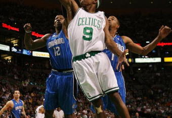 BOSTON - MAY 06:  Rajon Rondo #9 of the Boston Celtics goes up for a shot against Dwight Howard #12 and Rafer Alston #1 of the Orlando Magic  in Game Two of the Eastern Conference Semifinals during the 2009 NBA Playoffs at TD Banknorth Garden on May 6, 2009 in Boston, Massachusetts.  NOTE TO USER: User expressly acknowledges and agrees that, by downloading and or using this photograph, User is consenting to the terms and conditions of the Getty Images License Agreement.  (Photo by Elsa/Getty Images)
