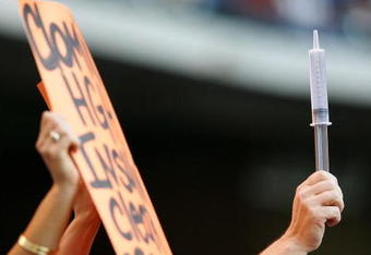 HOUSTON - MAY 16:  A fan holds a sign and a syringe for Barry Bonds #25 of the San Francisco Giants during a game against the Houston Astros on May 16, 2006 at Minute Maid Park in Houston, Texas.  (Photo by Jed Jacobsohn/Getty Images)