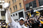 PITTSBURGH - FEBRUARY 03:  James Harrison #92 of the Pittsburgh Steelers shows off the Super Bowl XLIII trophy during a parade on February 3, 2009 in Pittsburgh, Pennsylvania.  (Photo by Gregory Shamus/Getty Images)