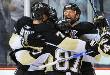 PITTSBURGH - MAY 06:  Mark Eaton #7, Sidney Crosby #87 and Bill Guerin #13 of the Pittsburgh Penguins celebrate with teammate Kris Letang #58 after Letang's overtime goal gave the Penguins a 3-2 win over the Washington Capitals in Game Three of the Eastern Conference Semifinal Round of the 2009 Stanley Cup Playoffs at Mellon Arena on May 6, 2009 in Pittsburgh, Pennsylvania.  (Photo by Jamie Sabau/Getty Images)