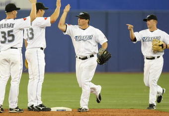 TORONTO - APRIL 6: (L-R) Lyle Overbay #35, Scott Rolen #33, Travis Snider #45, Aaron Hill #2 of the Toronto Blue Jays celebrate the win over the Detroit Tigers during the Opening Day game at the Rogers Centre on April 6, 2009 in Toronto, Ontario. (Photo by: Dave Sandford/Getty Images)