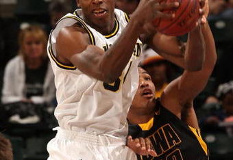 INDIANAPOLIS - MARCH 12:  DeShawn Sims #34 of the Michigan Wolveriens pulls down a rebound against Jarryd Cole #50 of the Iowa Hawkeyes during the first round of the Big Ten Men's Basketball Tournament at Conseco Fieldhouse on March 12, 2009 in Indianapolis, Indiana.  (Photo by Jonathan Daniel/Getty Images)