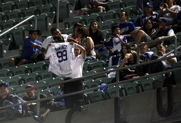 LOS ANGELES, CA - MAY 07:  A fan in the upper deck waves a Manny Ramirez jersey during the game between the Los Angeles Dodgers and  the Washington Nationals on May 7, 2009 at Dodger Stadiium in Los Angeles, California.  Ramirez was suspended for 50 games by Major League Baseball earlier in the day.  (Photo by Stephen Dunn/Getty Images)