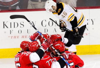 RALEIGH, NC - MAY 08:  The Carolina Hurricanes celebrate as David Krejci #46 Boston Bruins looks dejected during Game Four of the Eastern Conference Semifinal Round of the 2009 Stanley Cup Playoffs at RBC Center on May 8, 2009 in Raleigh, North Carolina.  (Photo by Streeter Lecka/Getty Images)