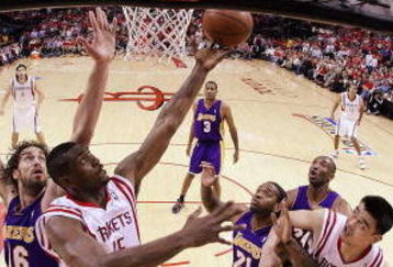 HOUSTON - MAY 08:  Guard Ron Artest #96 of the Houston Rockets takes a shot against Pau Gasol #16 of the Los Angeles Lakers in Game Three of the Western Conference Semifinals during the 2009 NBA Playoffs at Toyota Center on May 8, 2009 in Houston, Texas. NOTE TO USER: User expressly acknowledges and agrees that, by downloading and or using this photograph, User is consenting to the terms and conditions of the Getty Images License Agreement.  (Photo by Ronald Martinez/Getty Images)