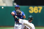OAKLAND, CA - MAY 7: Ian Kinsler #5 of the Texas Rangers throws to first base as Jack Hannahan #22 of the Oakland Athletics slides into second base on a double play hit by Orlando Cabrera #18 of the Athletics in the fourth inning during a Major League Baseball game at the Oakland Coliseum May 7, 2009 in Oakland, California. (Photo by Jed Jacobsohn/Getty Images)
