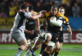 HAMILTON, NEW ZEALAND - MAY 09:  Sione Lauaki of the Chiefs (R) fends off Andrew Hore of the Hurricanes during the round 13 Super 14 match between the Chiefs and the Hurricanes at Waikato Stadium on May 9, 2009 in Hamilton, New Zealand.  (Photo by Sandra Mu/Getty Images)