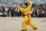 JIANGMEN, CHINA - FEBRUARY 15: A young member of 'Choy Lay Fut' lion dance group performs Kung Fu at a residential district on Febuary 15, 2005 in Jiangmen, Guangdong Province, China. The lion dance, which brings good luck to households or business visited by the lion, is a traditional part of the celebration for the Chinese New Year and is performed by two people- one at the head and one at the tail. Chinese lion dancing has been a popular form of martial art in China since its origin in approximately 400 B.C. (Photo by Cancan Chu/GettyImages)