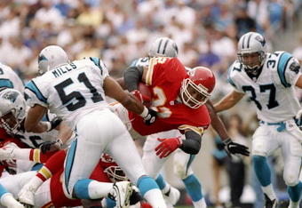 21 Sep 1997:  Running back Marcus Allen #32 of the Kansas City Chiefs slips past defenders Sam Mills #51 and Chad Cota #37 of the Carolina Panthers during the Chiefs 35-14 win at Ericcson Stadium in Charlotte, North Carolina. Mandatory Credit: Andy Lyons  /Allsport