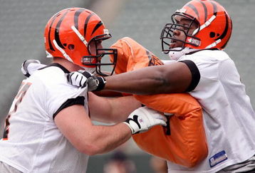 CINCINNATI, OH - MAY 1:  First round draft pick Andre Smith #7 (R) of the Cincinnati Bengals battles with teammate Ryan Madison #61 during rookie minicamp at Paul Brown Stadium on May 1, 2009 in Cincinnati, Ohio.  (Photo by Mark Lyons/Getty Images)