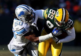 GREEN BAY, WI - DECEMBER 28: Ernie Sims #50 of the Detroit Lions brings down James Jones #89 of the Green Bay Packers on December 28, 2008 at Lambeau Field in Green Bay, Wisconsin. The Packers defeated the Lions 31-21. (Photo by Jonathan Daniel/Getty Images)