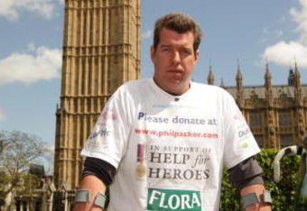 LONDON, ENGLAND - MAY 08: Phil Packer, who is walking the London Marathon, poses at the end of his penultimate day in front of Big Ben before entering the Houses of Parliament at the invitation of Conservative shadow defense secretary, Dr Liam Fox, on May 8, 2009 in London, England. Mr Packer was injured whilst serving in Iraq on the 19th February 2008 and is now a paraplegic. He is walking the route of the London Marathon in 13 days covering two miles per day and is hoping to raise £1 million for the wounded servicemen charity 'Help for Heroes'. He hopes to complete the full 26.2 mile course by 11am on May 9, 2009. (Photo by Oli Scarff/Getty Images)