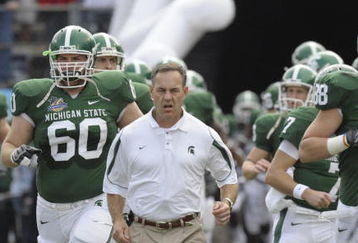 ORLANDO, FL - JANUARY 1: Coach Mark Dantonio of the Michigan State Spartans leads the team to the field for play against the Georgia Bulldogs at the 2009 Capital One Bowl at the Citrus Bowl on January 1, 2009 in Orlando, Florida.  (Photo by Al Messerschmidt/Getty Images) 