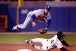 Roberto Alomar of the Toronto Blue Jays goes airbourne over Chicago White Sox Dan Pasqua to convert the double play. Mandatory Credit: Jonathan Daniel/ALLSPORT