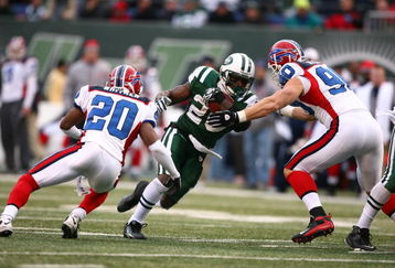 EAST RUTHERFORD, NJ - DECEMBER 14:  Thomas Jones #20 of the New York Jets runs into Chris Kelsay #90 and Donte Whitner #20 of the Buffalo Bills during their game on December 14, 2008 at Giants Stadium in East Rutherford, New Jersey.  (Photo by Al Bello/Getty Images)