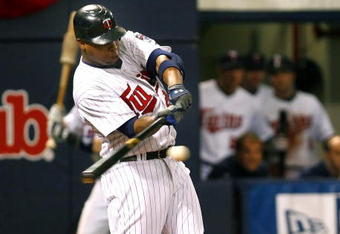 MINNEAPOLIS, MN- SEPTEMBER 28: Delmon Young #21 of the Minnesota Twins singles in the seventh inning scoring Alexi Casilla and Joe Mauer in a game against the Kansas City Royals at the Metrodome on September 28, 2008 in Minneapolis, Minnesota. The Twins defeated the Royals 6-0. (Photo by Scott A. Schneider/Getty Images)