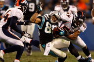 CHARLOTTE, NC - DECEMBER 14: Wesley Woodyard #59 of the Denver Broncos tackles Steve Smith #89 of the Carolina Panthers during their game at Bank of America Stadium on December 14, 2008 in Charlotte, North Carolina (Photo by Streeter Lecka/Getty Images)