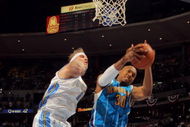 DENVER - APRIL 29: David West #30 of the New Orleans Hornets grabs a rebound away from Chris Andersen #11 of the Denver Nuggets in Game Five of the Western Conference Quarterfinals during the 2009 NBA Playoffs at Pepsi Center on April 29, 2009 in Denver, Colorado. The Nuggets defeated the Hornets 107-86 to advance to the Western Conference Semifinals against Dallas. NOTE TO USER: User expressly acknowledges and agrees that, by downloading and or using this photograph, User is consenting to the terms and conditions of the Getty Images License Agreement. (Photo by Doug Pensinger/Getty Images)