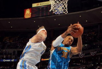 DENVER - APRIL 29:  David West #30 of the New Orleans Hornets grabs a rebound away from Chris Andersen #11 of the Denver Nuggets in Game Five of the Western Conference Quarterfinals during the 2009 NBA Playoffs at Pepsi Center on April 29, 2009 in Denver, Colorado. The Nuggets defeated the Hornets 107-86 to advance to the Western Conference Semifinals against Dallas. NOTE TO USER: User expressly acknowledges and agrees that, by downloading and or using this photograph, User is consenting to the terms and conditions of the Getty Images License Agreement.  (Photo by Doug Pensinger/Getty Images)