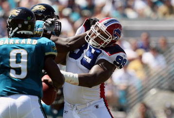 JACKSONVILLE, FL - SEPTEMBER 14:  Defensive tackle Marcus Stroud #99 of the Buffalo Bills tries to turn the corner and get to quarterback David Garrard #9 of the Jacksonville Jaguars at Jacksonville Municipal Stadium on September 14, 2008 in Jacksonville, Florida. The Bills defeated the Jaguars 20-16.  (Photo by Doug Benc/Getty Images)